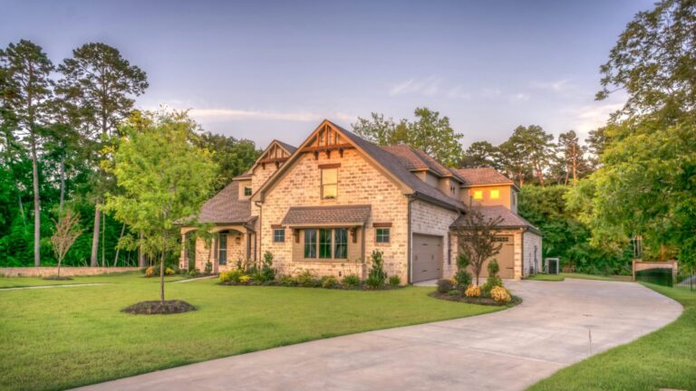 home with a long driveway surrounded by trees