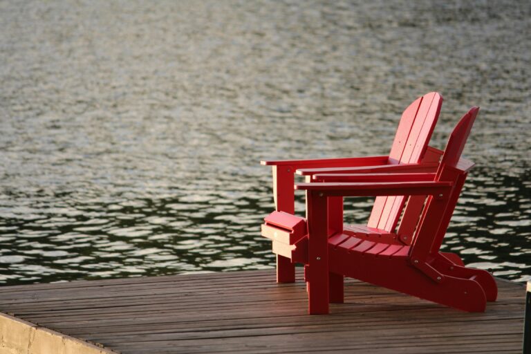 Adirondack chairs on a lake dock in the Ozarks - a peaceful retirement lifestyle awaits those retiring in the Ozarks