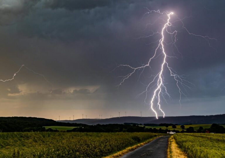 Lightning over a rural Ozarks road — severe weather is one of the pros & cons of living in the Ozarks