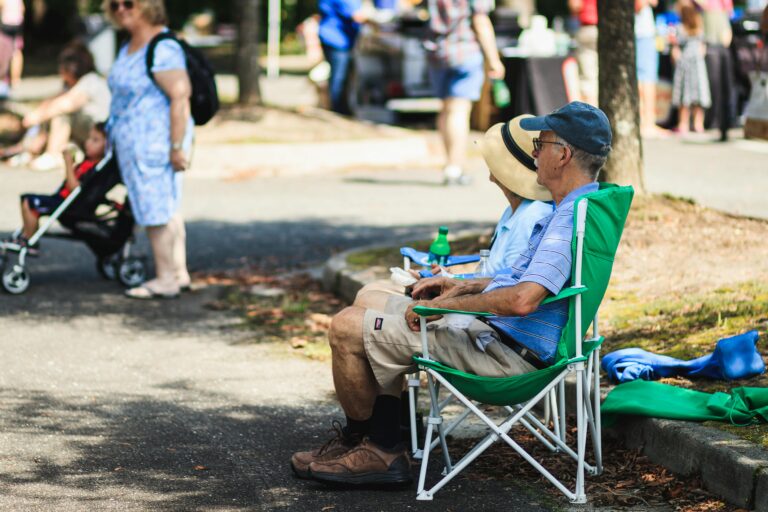 Man relaxing at a community festival in the Ozarks, enjoying the friendly small-town culture