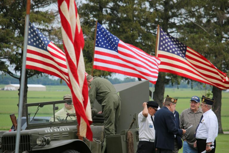 U.S. military veterans with American flags at a parade