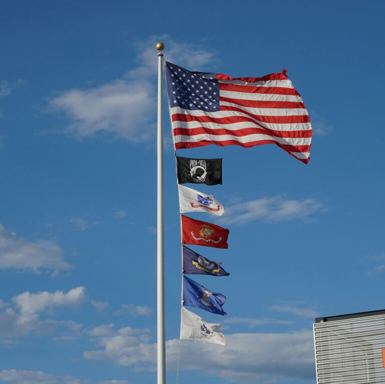 U.S. flag flying above U.S. military branch flags