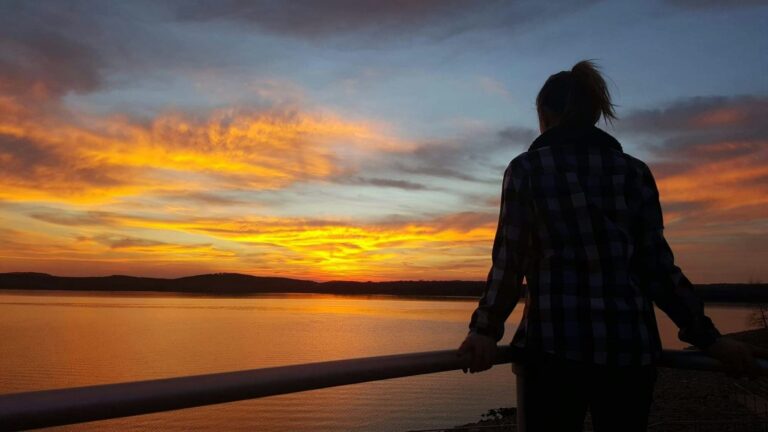 Woman at sunset overlooking Table Rock Lake contemplating her next move.