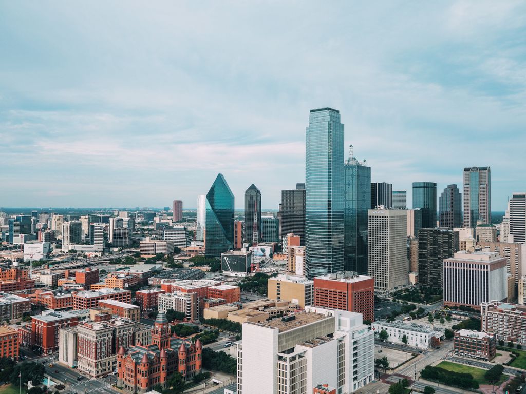 Aerial view of the vibrant Dallas skyline with iconic skyscrapers and urban landscape.